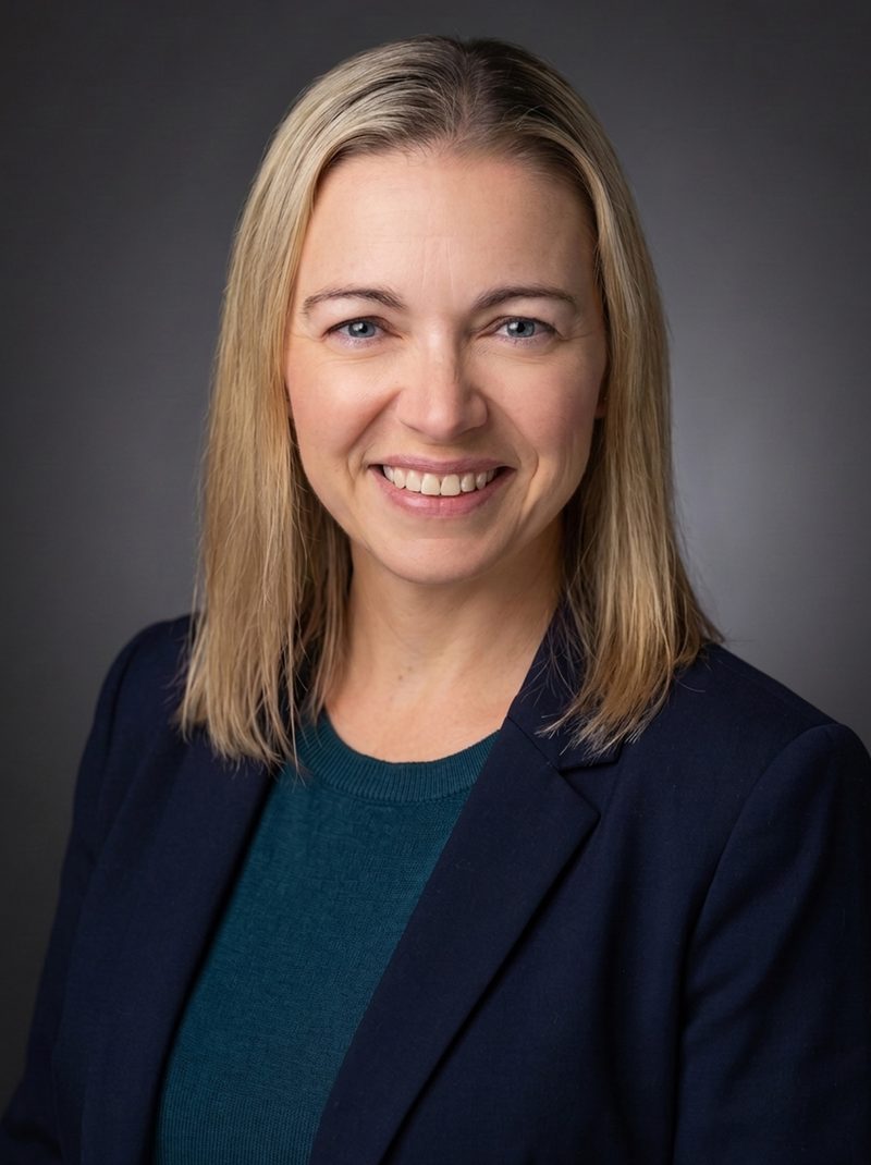 AI headshot on a charcoal grey studio backdrop with spot lighting